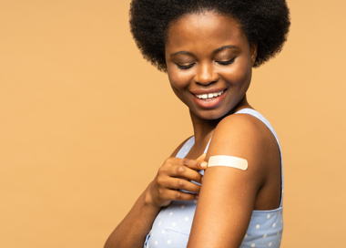 A person smiling and holding the belly.