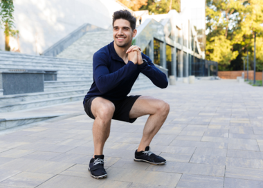 A person sitting on a stone walkway.
