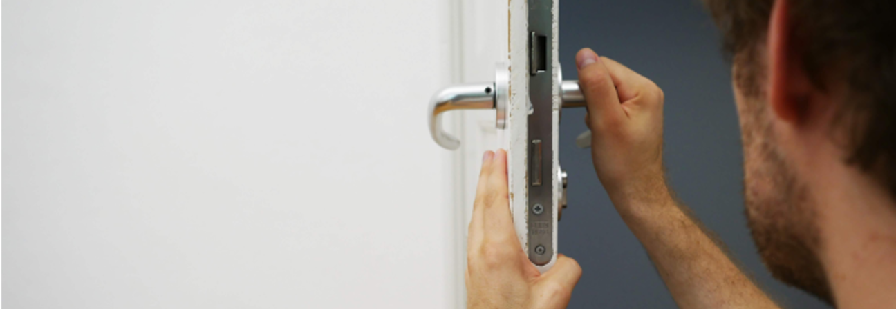 A man holding a door handle.