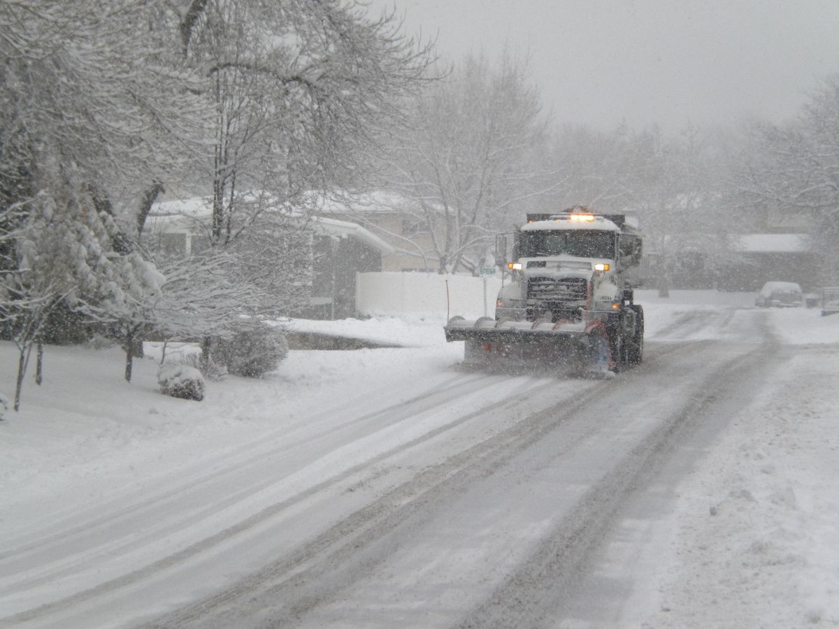 A truck driving on a snowy road.