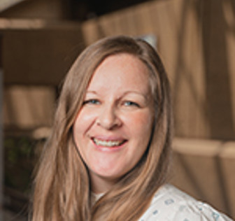 A woman smiling at the camera.