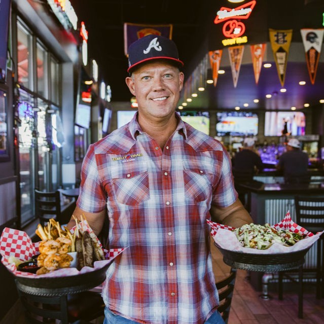 A man holding a tray of food.