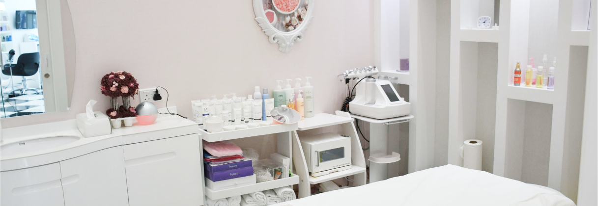 A white room with a sink and shelves with objects on them.