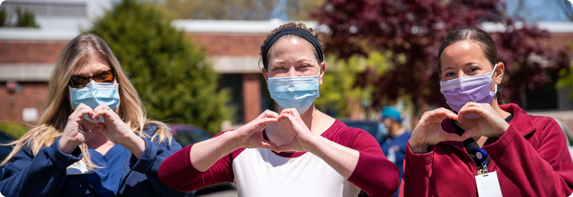 A group of women holding up their glasses.