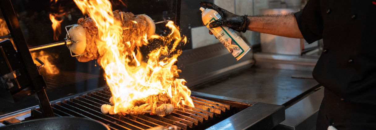 A person putting food on a grill.