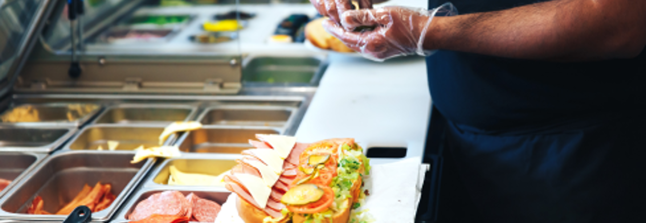 A person preparing food in a restaurant.