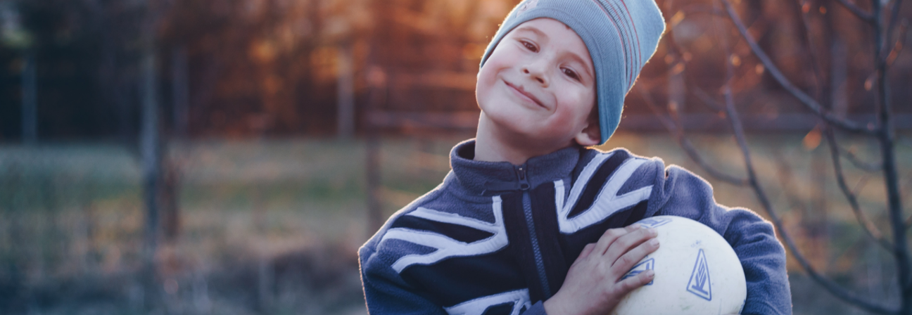 A boy holding a ball.
