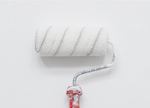 A white t-shirt with a red string tied around it.