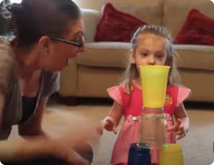 A person and a girl drinking juice.