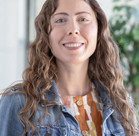 A woman with long hair smiling.