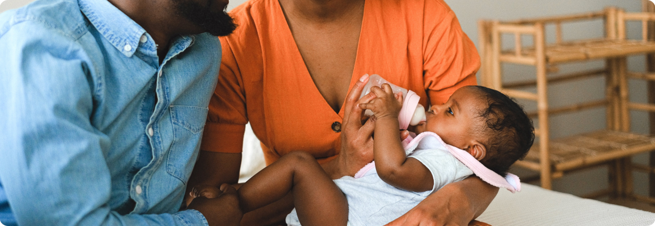 A baby being held by a doctor.