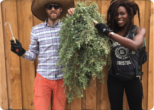 A man and woman holding a pineapple.