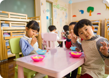 A group of children eating at a table.