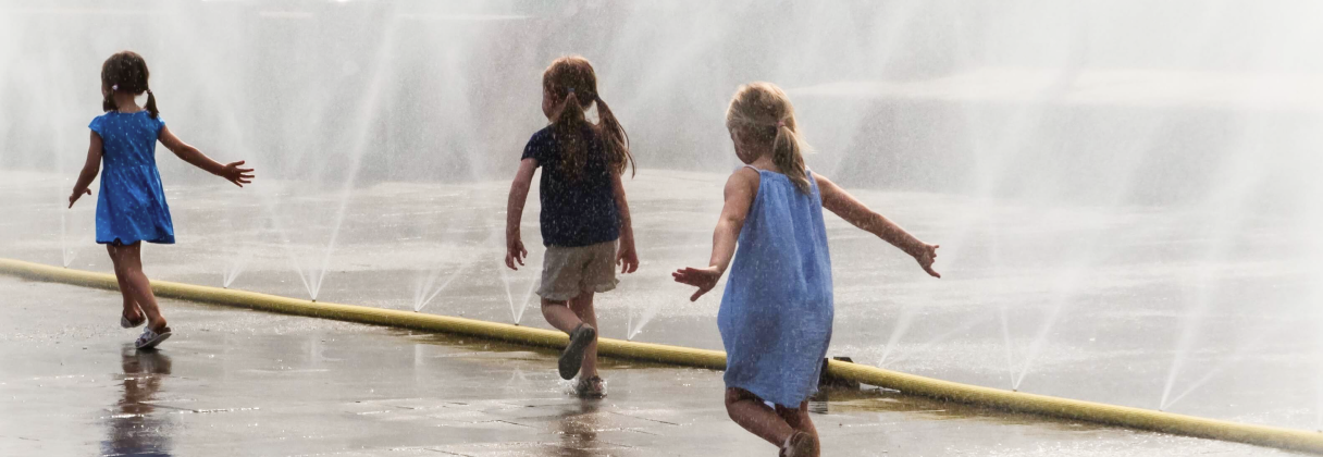 A group of people running on a beach.