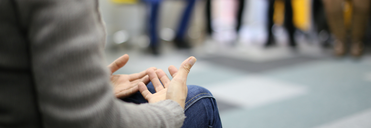 A person's hands on a bench.
