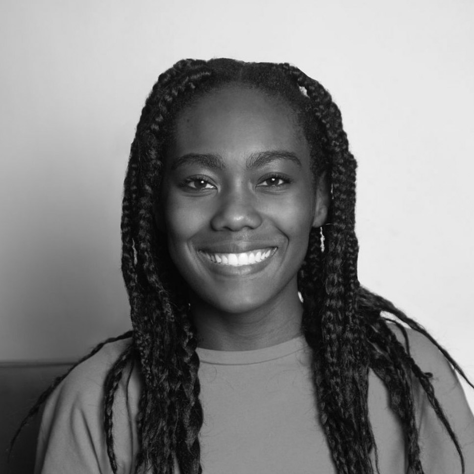 A person with long hair smiling.