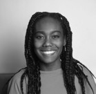 A person with long hair smiling.