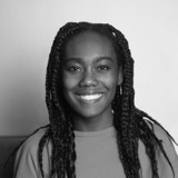 A person with long hair smiling.