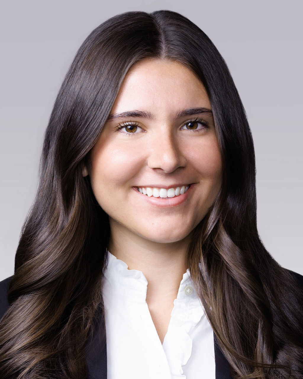 A woman with long hair smiling.