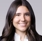 A woman with long hair smiling.