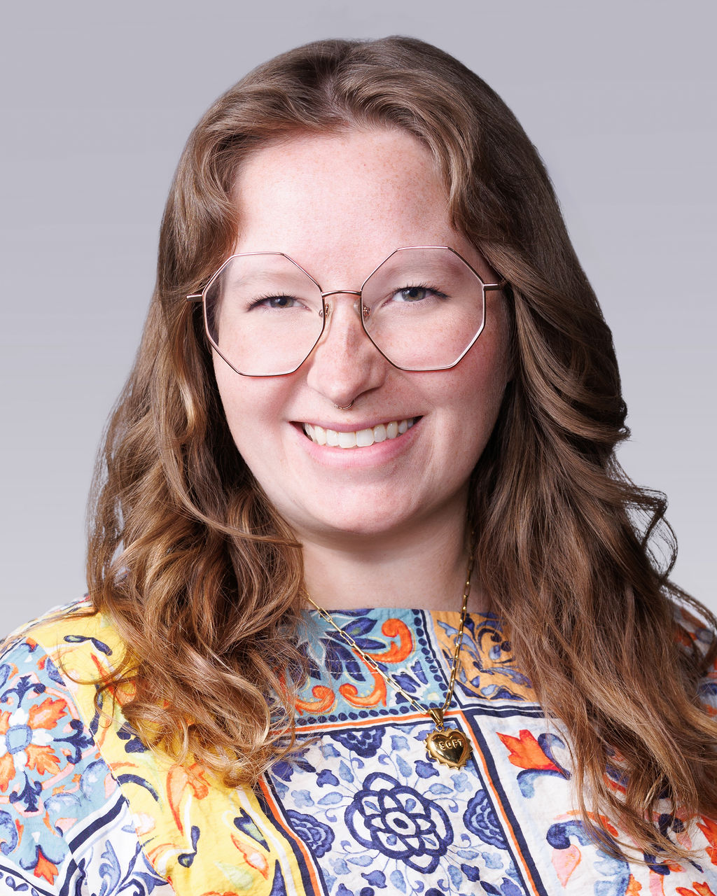 A person with long hair and glasses.