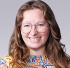 A person with long hair and glasses.