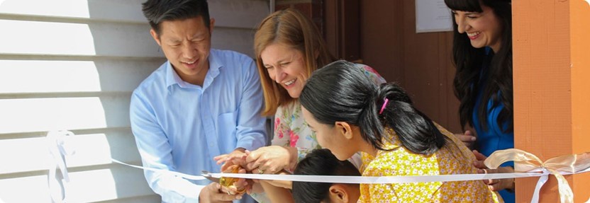 A group of people looking at a paper.