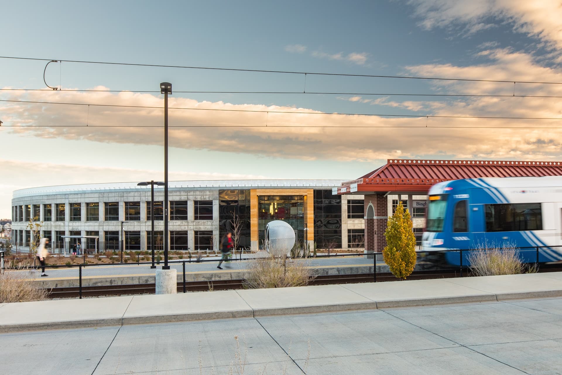 A train station with a few people.