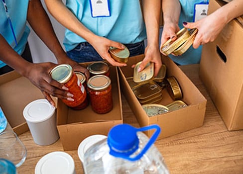 A group of people holding containers of food.