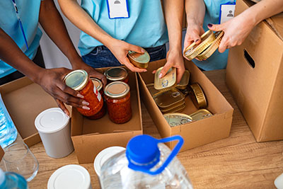A group of people holding containers of food.