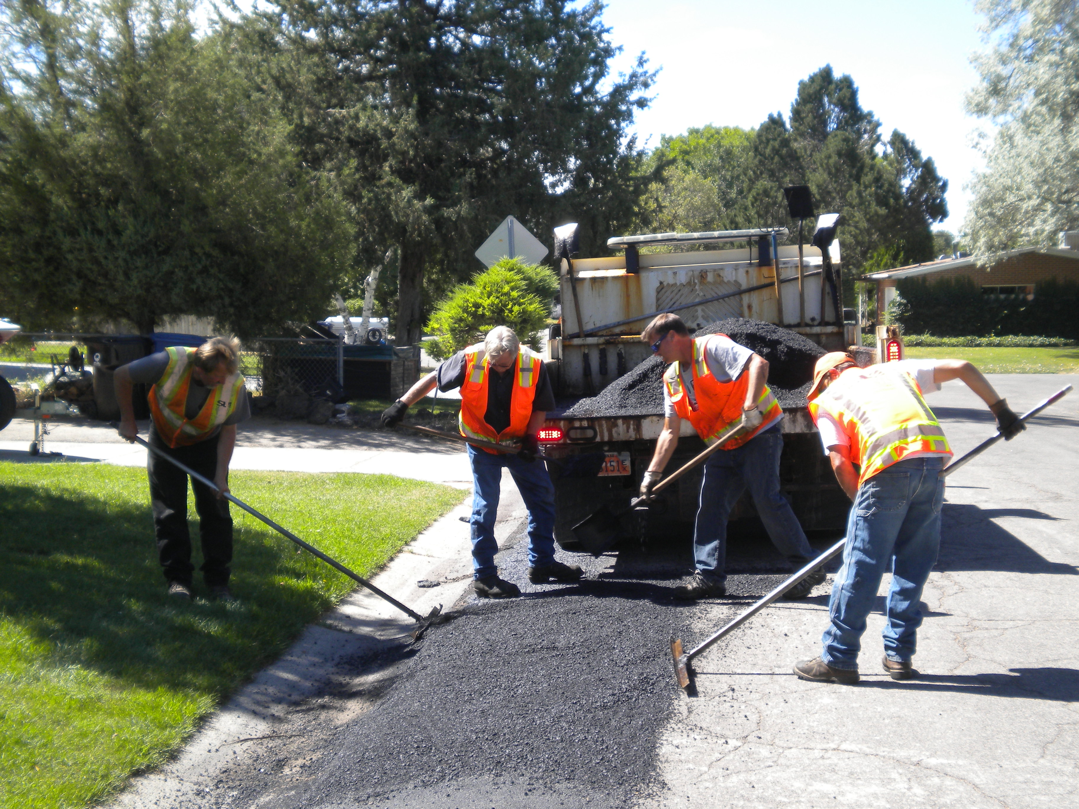 A group of people working on a road.