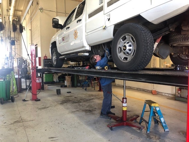 A person working on a car.