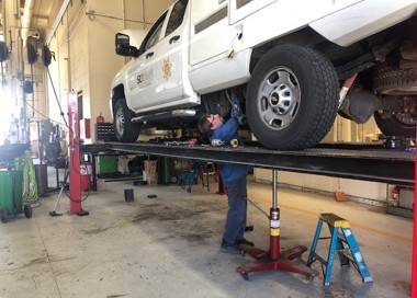 A person working on a car.