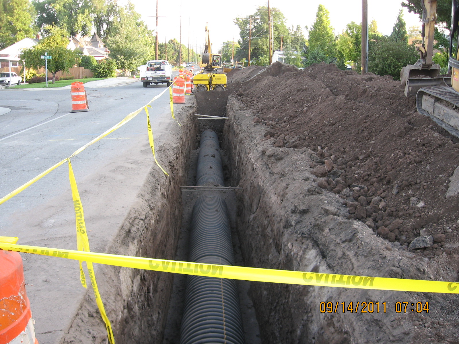 A road with a pile of dirt and a pile of dirt.