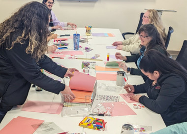 A group of people sitting around a table.