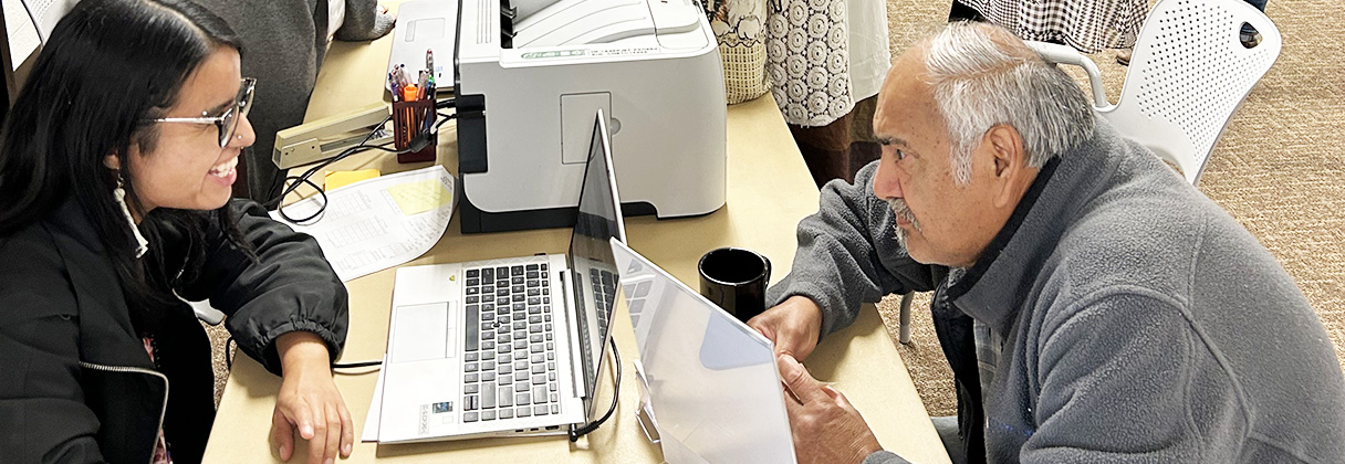 A man and a woman looking at a laptop.