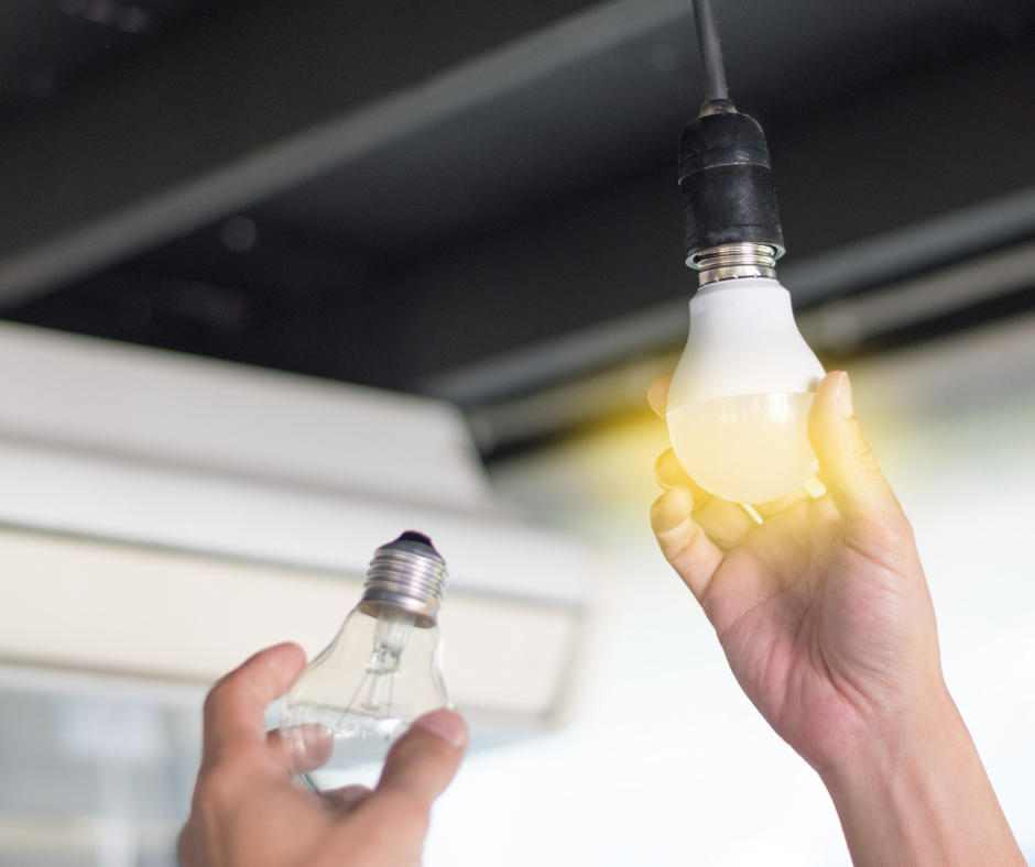 A person holding a light bulb.