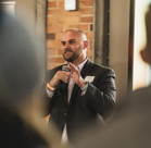 A man in a suit holding a phone to his ear.