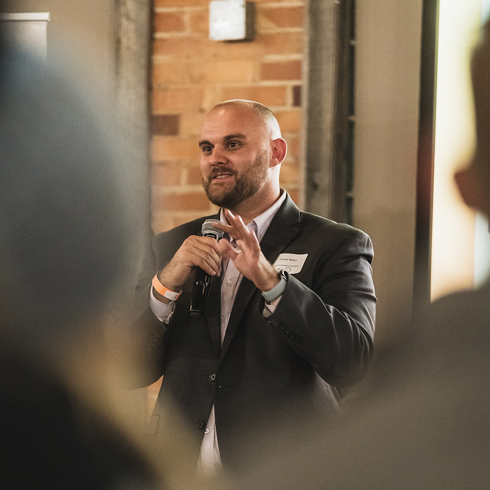 A man in a suit holding a phone to his ear.