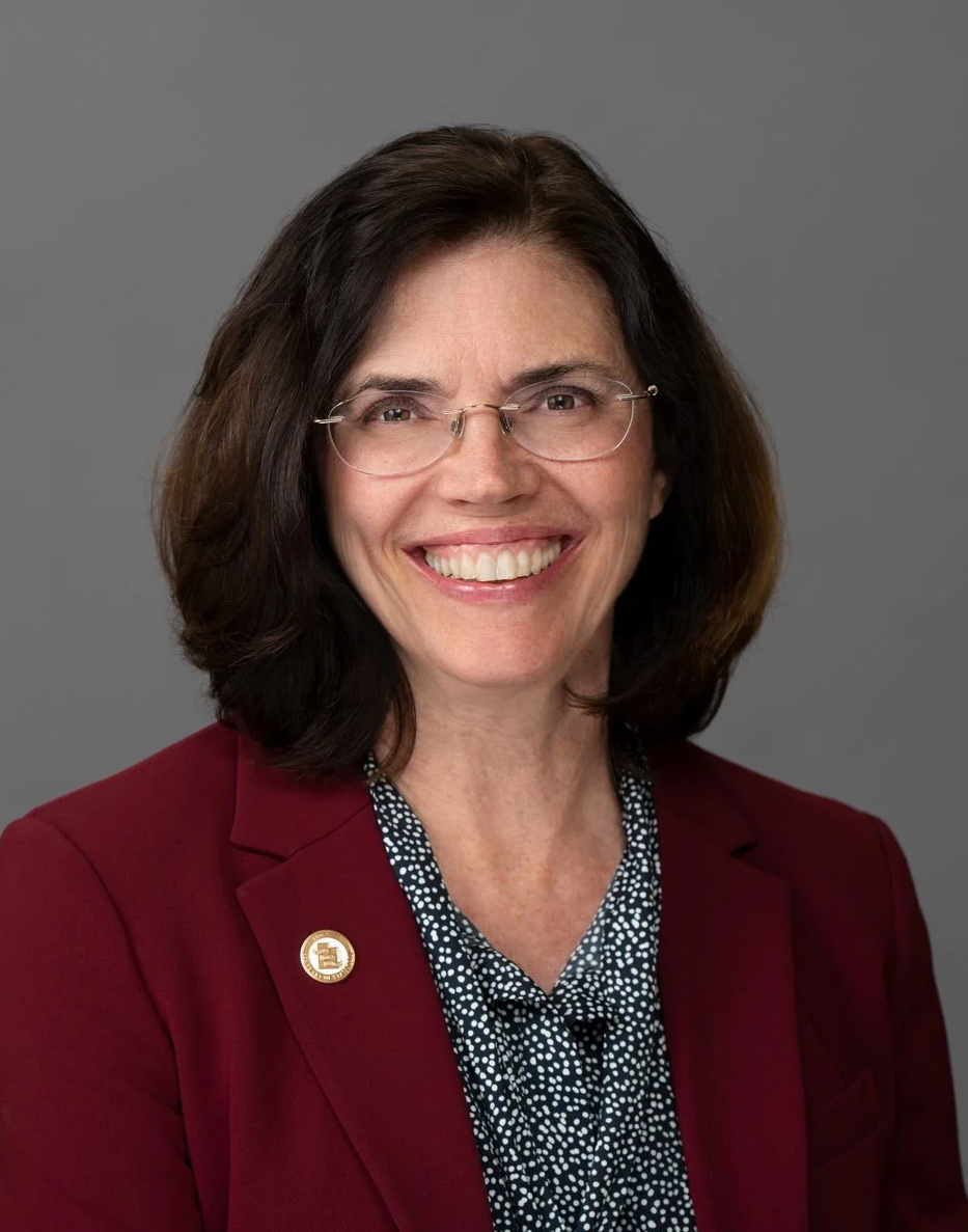 A woman wearing glasses.