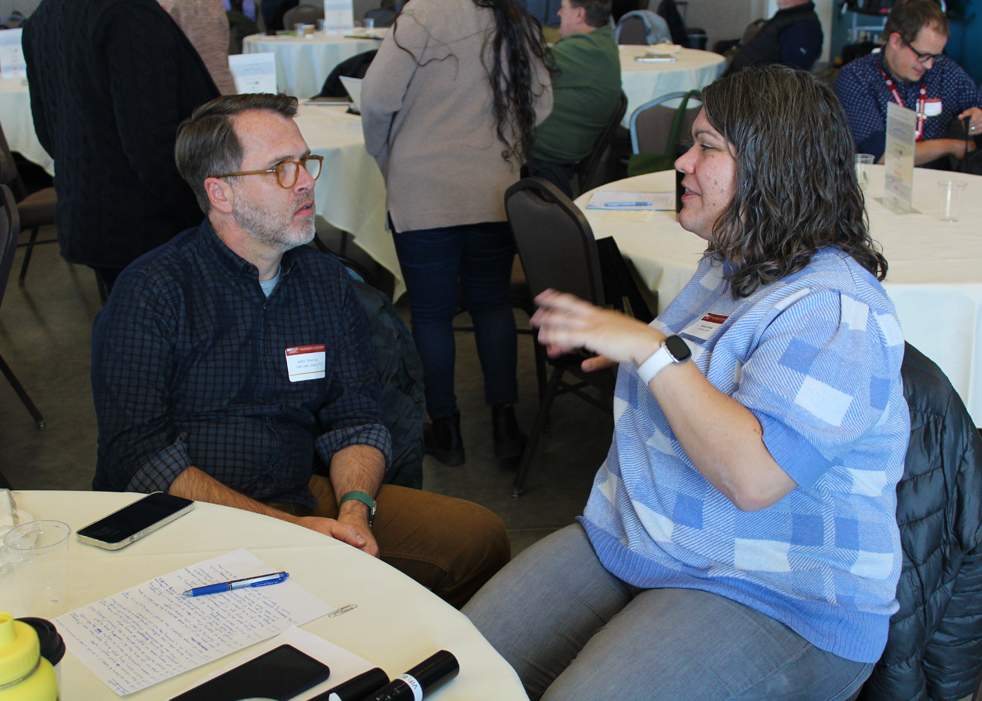 A man and a woman sitting at a table.