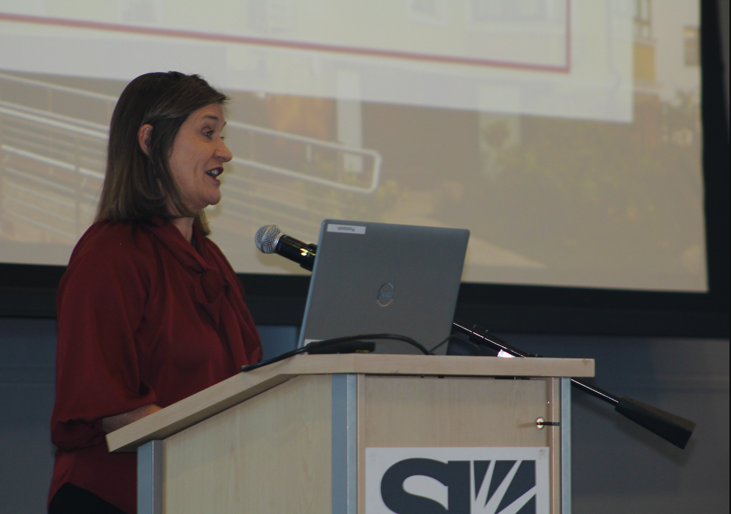 A person speaking into a microphone.