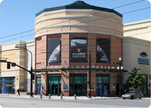 A building with a car parked in front of it.