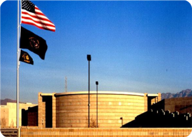 A few flags flying in front of a building.