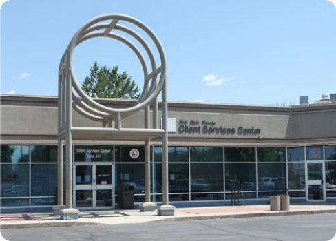 A building with a large sculpture in front of it.