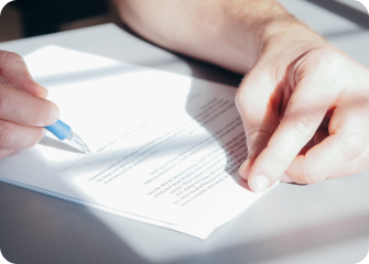 A person writing on a piece of paper.