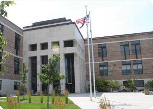 A flagpole in front of a building.