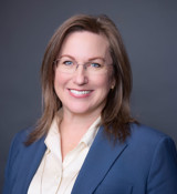 A woman wearing glasses.