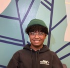 A boy wearing glasses and a hat.