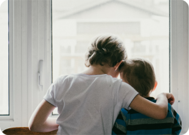 A person and a child looking at a window.